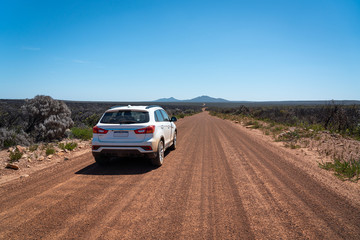 Fototapeta na wymiar Car on an empty gravel road