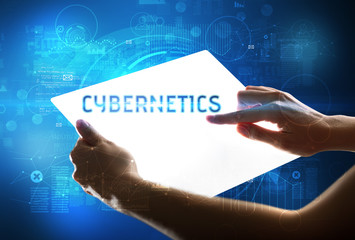 Hand holdig futuristic tablet with CYBERNETICS inscription, new technology concept