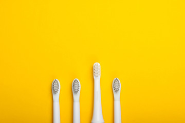 Headы of toothbrush on a yellow background. Top view