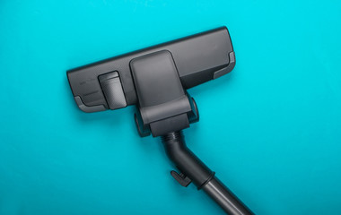 Vacuum cleaner brush on a blue background. Top view. Cleaning concept.