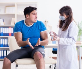 Fototapeta premium Patient visiting doctor after sustaining sports injury