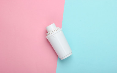 Filter element of water purifier on pink blue pastel background. Top view