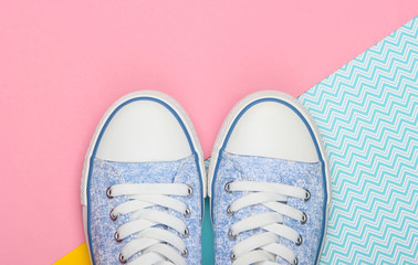 Old-fashioned retro sneakers on a colored background. Pastel color trend. Top view