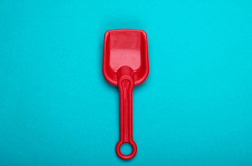 Children's shovel for a sandbox or beach on blue background. Top view