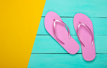 Flip flops on a yellow, blue wooden background. Top view. Beach Vacation Concept