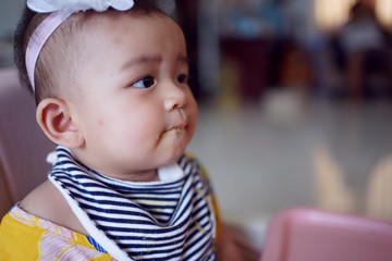 Infant girls eating mashed potatoes mixed with water