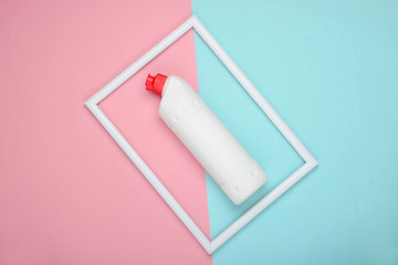 Bottle of detergent on a pink-blue pastel background with a white frame. Top view. Minimalism