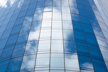 Reflection of sky in glass of office building ; abstract background