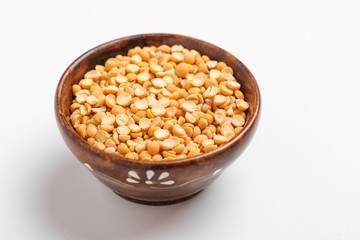 Dried chickpea lentils in wooden bowl on white background , Split Chickpea Also Know as Chana Dal