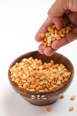 Dried chickpea lentils in wooden bowl on white background , Split Chickpea Also Know as Chana Dal