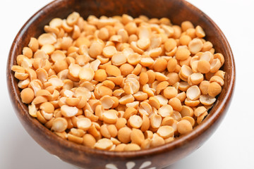 Dried chickpea lentils in wooden bowl on white background , Split Chickpea Also Know as Chana Dal