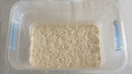 Dough in a plastic container. Healthy eating.