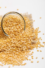 yellow moong mung dal lentil pulse bean in glass bowl on white background
