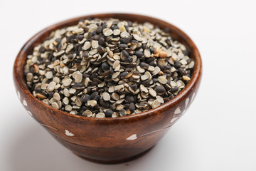 Split Black Lentil Also Know as Black Gram, Black Urad Dal, Vigna Mungo, Urad Bean in wooden bowl on white background