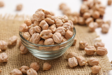 Uncooked dried chickpeas in glass bowl