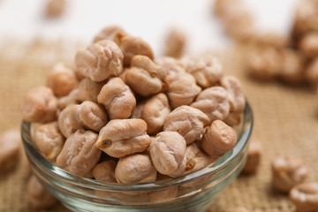 Uncooked dried chickpeas in glass bowl