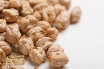 Uncooked dried chickpeas on white background