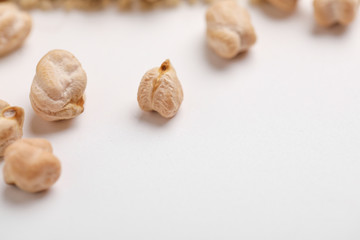Uncooked dried chickpeas on white background