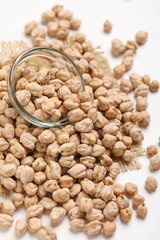 Uncooked dried chickpeas in glass bowl
