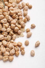 Uncooked dried chickpeas on white background