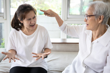 Angry elderly people has quarrel violently with aggressive woman at home,annoyed senior mother pointing finger to daughter,arguing yell at each other,ungrateful,bad relations,family conflict concept