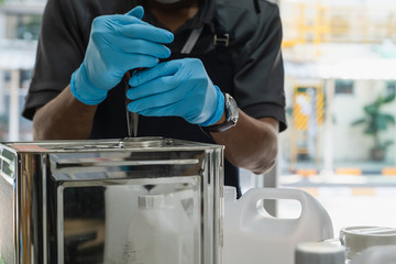 The scientists inject chemicals into plastic tubes,Scientist mix alcohol 75% Hand wash gel Kill the disease Covid 19 In the laboratory prepare sample for test Produce 75% alcohol