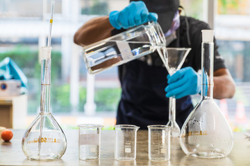 The scientists inject chemicals into plastic tubes,Scientist mix alcohol 75% Hand wash gel Kill the disease Covid 19 In the laboratory prepare sample for test Produce 75% alcohol