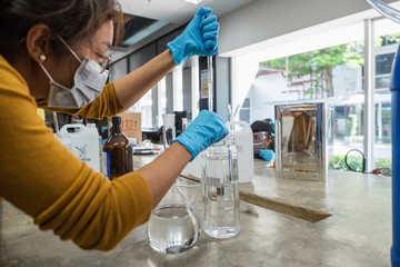 The scientists inject chemicals into plastic tubes,Scientist mix alcohol 75% Hand wash gel Kill the...