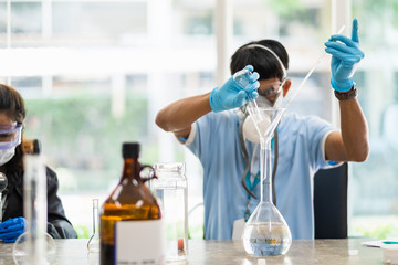 The scientists inject chemicals into plastic tubes,Scientist mix alcohol 75% Hand wash gel Kill the disease Covid 19 In the laboratory prepare sample for test Produce 75% alcohol