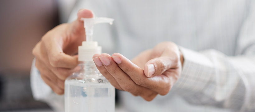 Man Hands Using Wash Hand Alcohol Gel Or Sanitizer Bottle Dispenser, Against Novel Coronavirus Or Corona Virus Disease (Covid-19) . Antiseptic, Hygiene And Health Concept