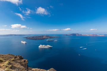 Fototapeta na wymiar Beautiful landscape with sea view. Cruise ships at the sea near the islands. Santorini island, Greece.