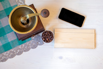 Old coffee grinder and coffee beans on white background with space for your text