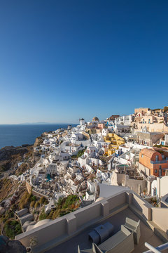 Traveling concepts. Picturesque view of beautiful and colorful houses of Greek Traditional Oia or village at Santorini Island in Greece. Vertical vacation image background