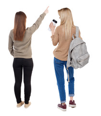 Back view of two pointing girl in sweater.