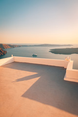 White architecture over street and sea view. Tranquil summer travel and vacation. Beautiful sunset on Santorini island, Greece.