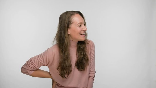 portrait of a flirting and smiling woman in a pink blouse