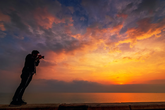 An adventure photographer sightseeing in Khobar sea side sunrise background. City : Khobar/ Saudi Arabia.