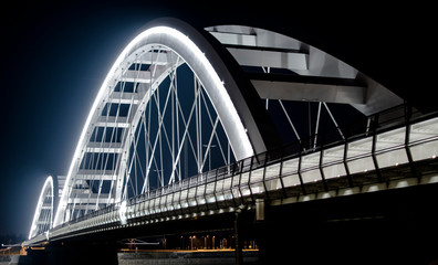Fototapeta na wymiar Arch Bridge by night. White bridge. Suspension bridge.