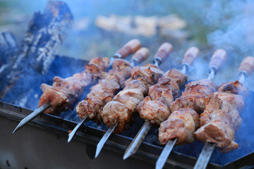 Cooking delicious skewers of meat on the grill on skewers