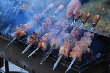 Cooking delicious skewers of meat on the grill on skewers