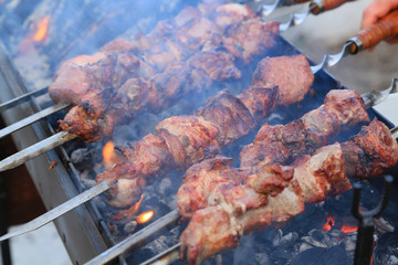 Cooking delicious skewers of meat on the grill on skewers