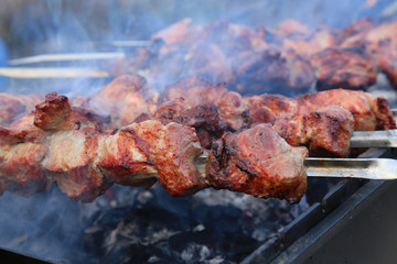 Cooking delicious skewers of meat on the grill on skewers