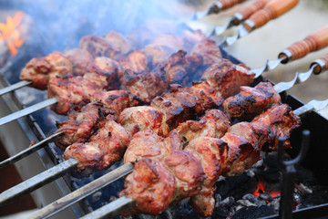 Cooking delicious skewers of meat on the grill on skewers