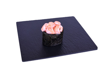 Traditional fresh japanese sushi on black stone Gunkan ebi on a white background. Gunkan ingredients: tiger shrimp, nori, rice.
