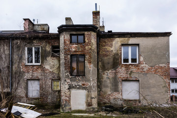 Abandoned house. The rear facade.  Staircase, brick and plaster, blocked window . Good material for...