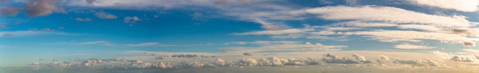 Fantastic clouds against blue sky, panorama