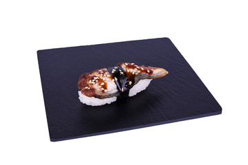 Traditional fresh japanese sushi on black stone Nigiri unagi on a white background. Gunkan...