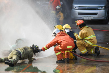 Firefighters using extinguisher