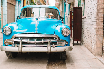 View of yellow classic vintage car in Old Havana, Cuba