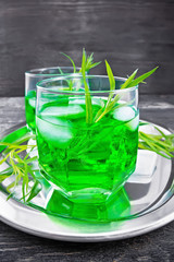 Lemonade Tarragon with ice in two glasses on board